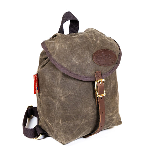 A small knapsack made from water-resistant waxed canvas.