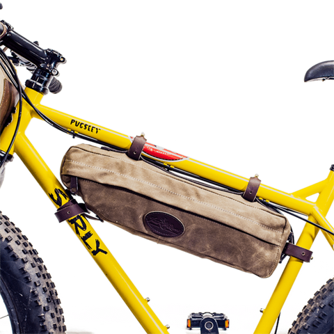 This bike bag connects to the inside of the bike frame with four adjustable leather straps connected to solid brass posts.