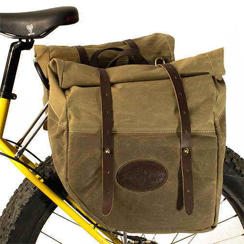 These panniers are handcrafted with premium American sourced waxed canvas, leather, and brass.