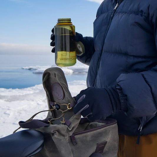 Grabbing a water bottle out of the Taconite Bike Trunk Bag