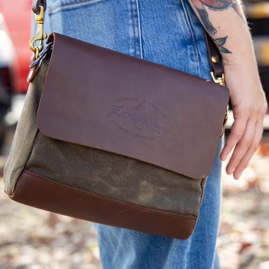 Woman carrying a waxed canvas and leather shoulder bag