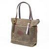 Side view of a waxed canvas and leather tote bag.