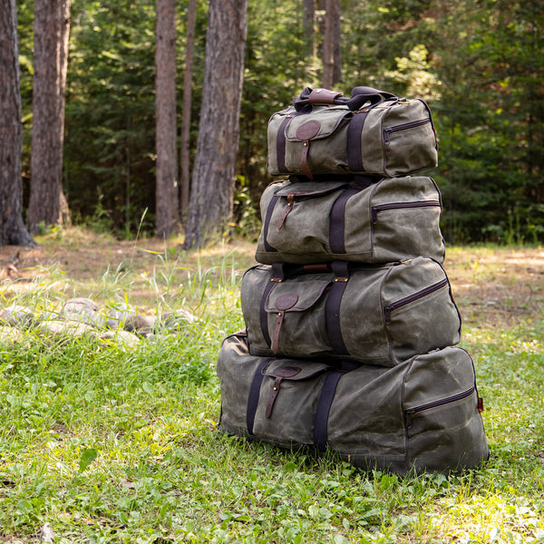 All four sizes of Frost River's Explorer Duffel Bags stacked up. 