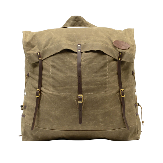 A large traditional style waxed canvas canoe pack with full-grain leather and solid brass hardware. 