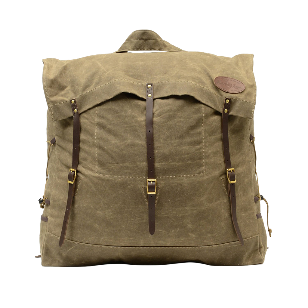 A large traditional style waxed canvas canoe pack with full-grain leather and solid brass hardware. 