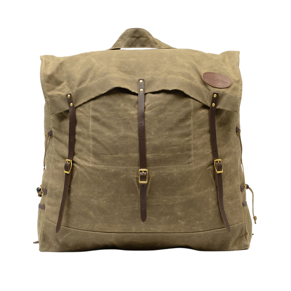 A large traditional style waxed canvas canoe pack with full-grain leather and solid brass hardware. 