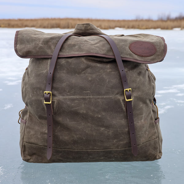A traditional style canoe pack made from waxed canvas, full-grain leather, and solid brass hardware. 