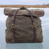 A traditional style canoe pack made from waxed canvas, full-grain leather, and solid brass hardware. 