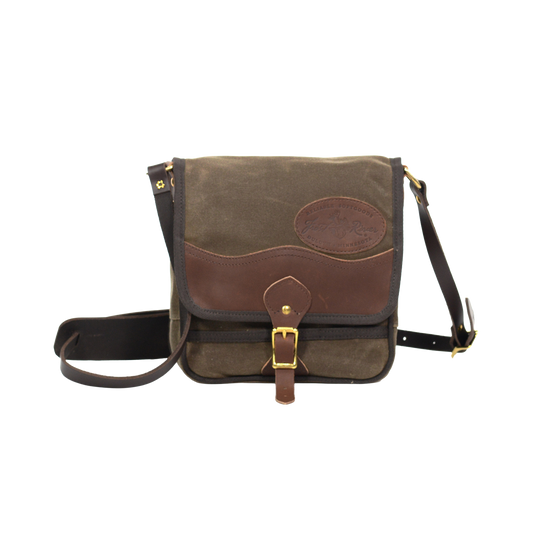Timeless shoulder bag made from waxed canvas, premium leather, and solid brass.