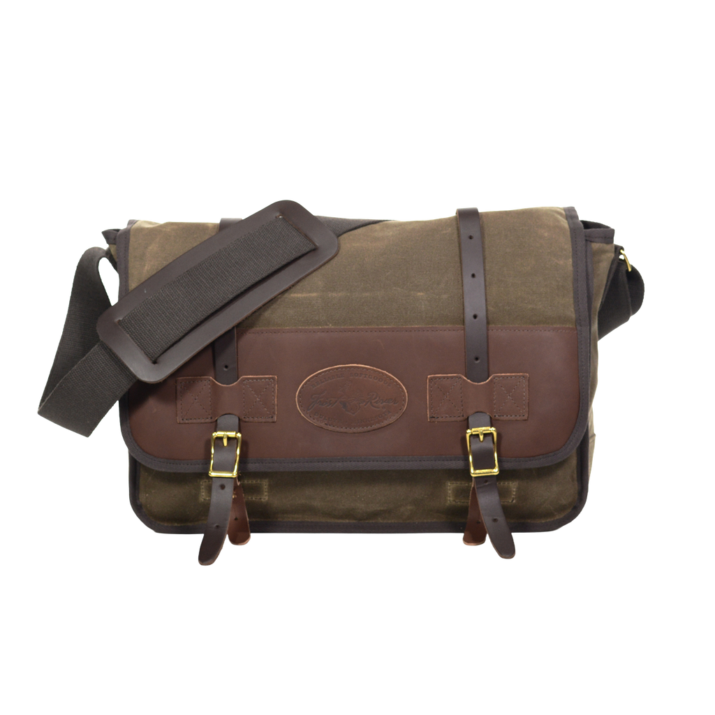 The Vintage Messenger Bag handcrafted out of premium leather, high quality waxed canvas, and sold brass. With two leather straps being secured down by two brass buckles. 