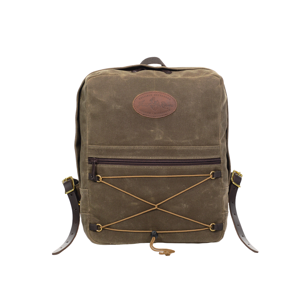 The Itinerant Daypack made out of our forrest green waxed canvas has a small zippered pocket in the front. On front of that pocket is same colored cord  in a hourglass shape for additional storage.
