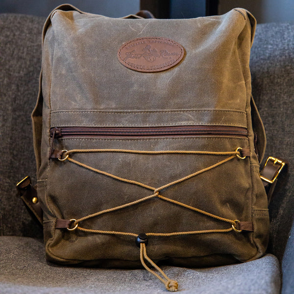 A waxed canvas backpack with leather straps that was made in Duluth, Minnesota