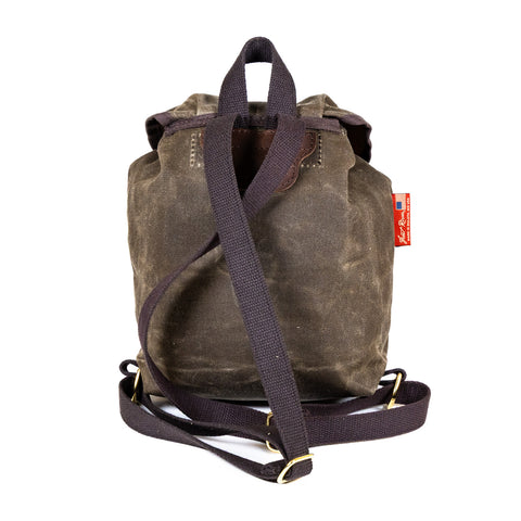 A small waxed canvas knapsack with cotton web shoulder straps. 