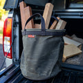 A four gallon waxed canvas bucket carrying small wood pieces to the wood shop. 