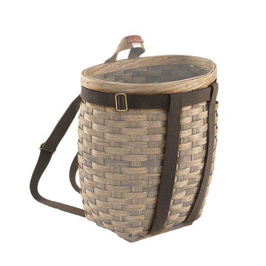 A traditional woven basket with a brown cotton web harness equipped with solid brass hardware.