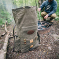 Field tan waxed canvas rolltop backpack at camp.