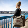 A woman in canal park wearing a Frost River waxed canvas Boardwalk Tote. 