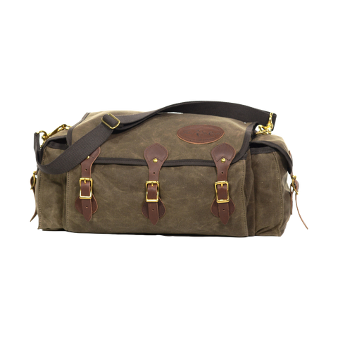 A soft sided tackle box crafted from waxed canvas, leather, and solid brass. 