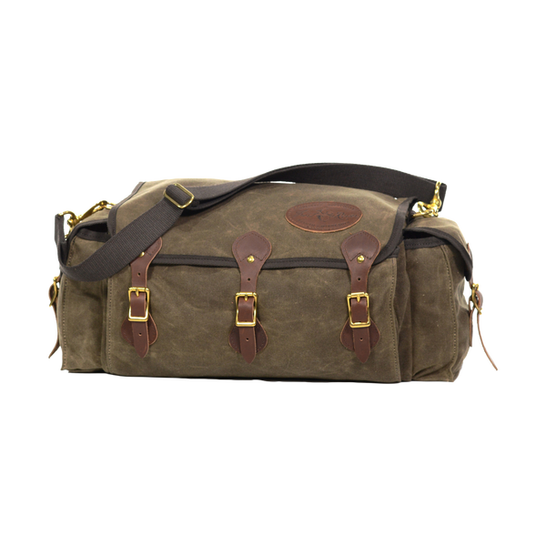 A soft sided tackle box crafted from waxed canvas, leather, and solid brass. 