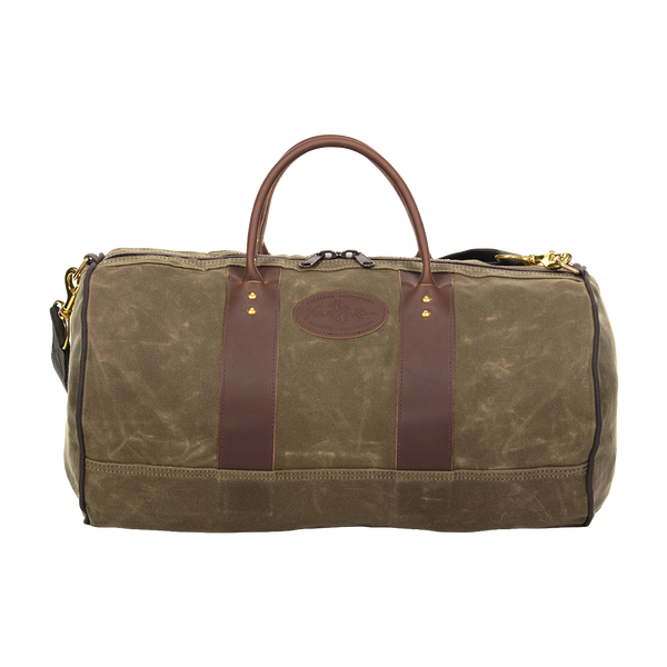 Classic round shaped duffel bag made from 18 ounce waxed canvas, full grain leather, and solid brass hardware.