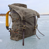 A waxed canvas canoe pack with buckskin padded straps and a traditional tumpline. 