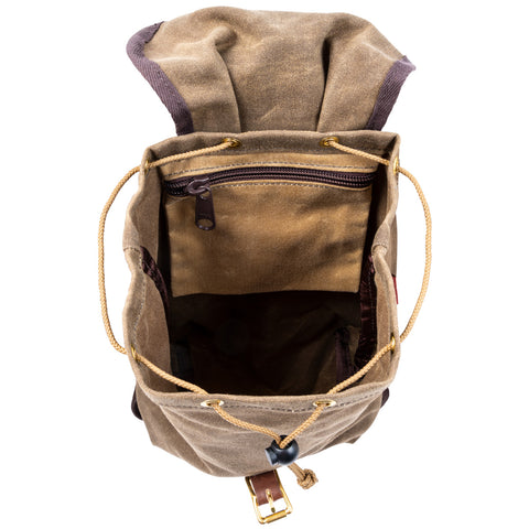 A small waxed canvas knapsack with the lid open showing off that it has hanging zippered pocket on the inside. 