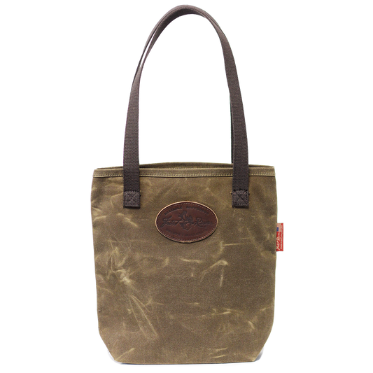 A waxed canvas tote bag with cotton web handles and a leather patch on the front.