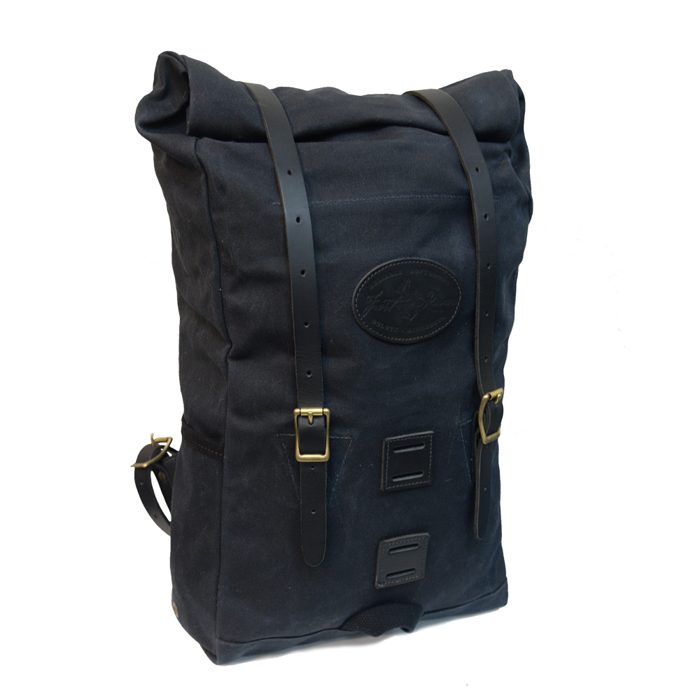 Front view of Heritage black version of backpack fully packed to show expansion capabilities waxed canvas with black leather straps 