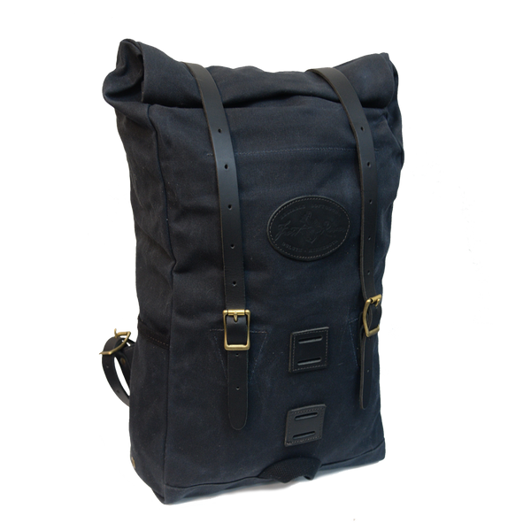 Front view of Heritage black version of backpack fully packed to show expansion capabilities waxed canvas with black leather straps 