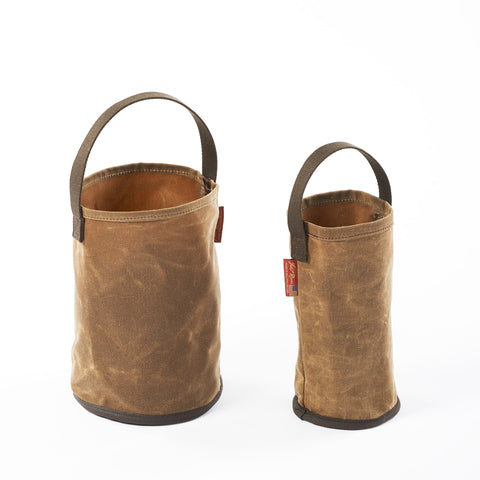 Handcrafted waxed canvas bucket that can be used to carry water to camp or any other item foraged from the woods.