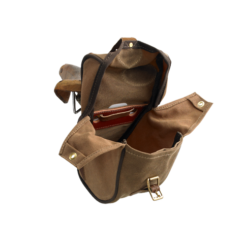 Inside is a medium sized main compartment with two waxed canvas flaps. Materials are sourced within the USA and handcrafted in Duluth MN.