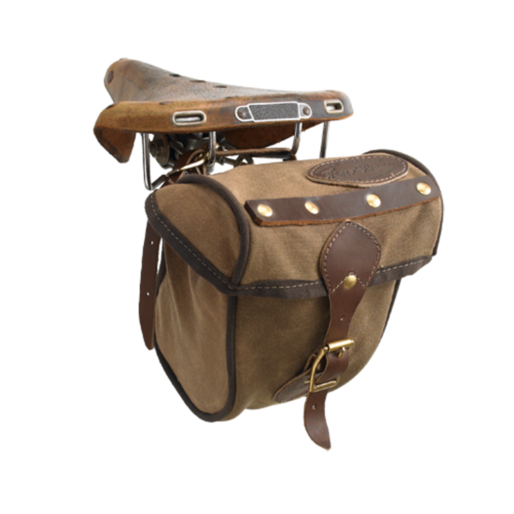 The Eco Trail Seat Bag is crafted out our high quality waxed canvas, high grade premium leather, and durable solid brass. A leather strap with a brass buckle keeps this bag shut.
