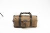 Waxed canvas duffle bag with cotton webbed grab handles and shoulder strap.