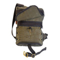 Frost view of sling pack shown with open flap to see large front zipper pocket and a cord and barrel tie down system for a jacket or blanket