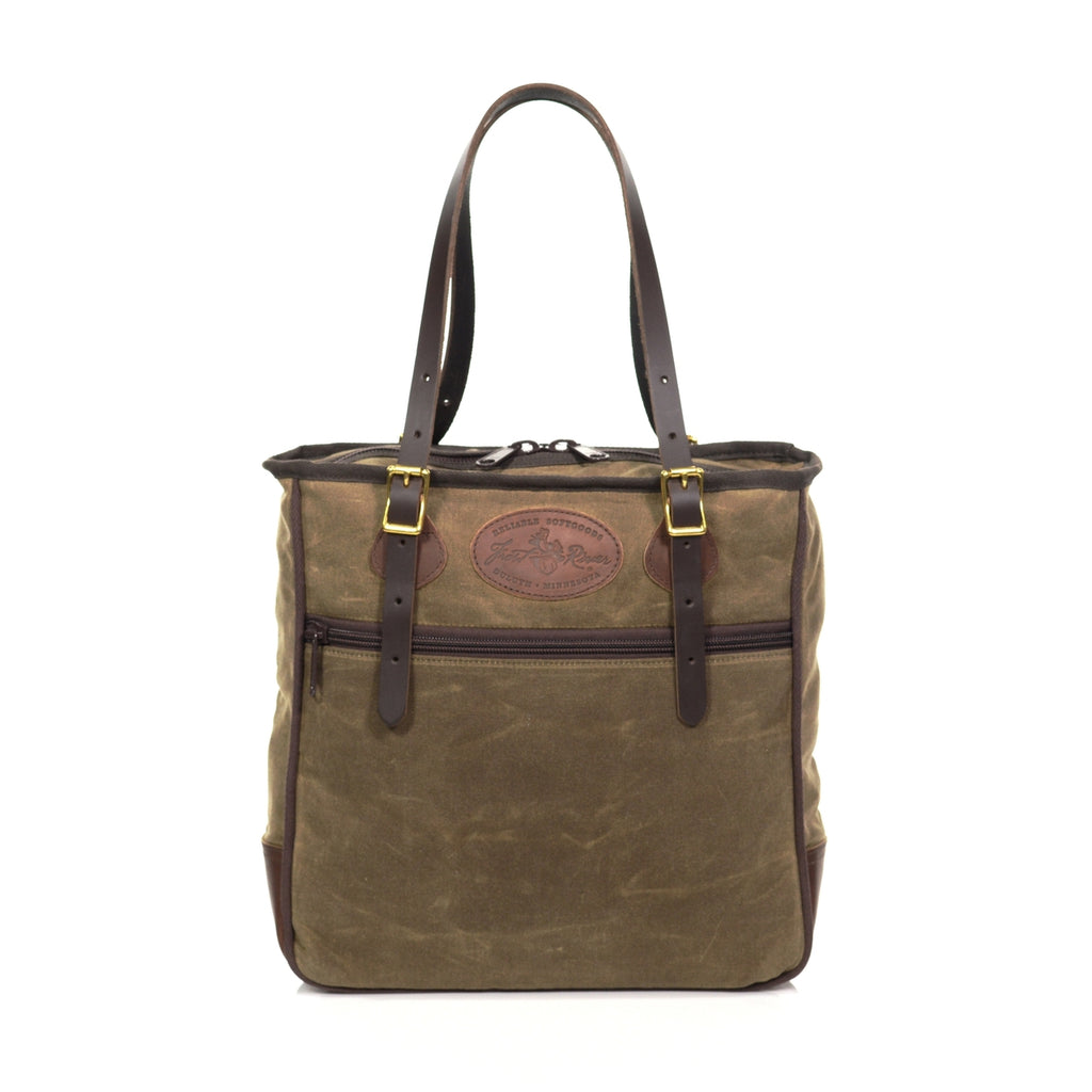 Large tote bag with adjustable leather straps connected with solid brass buckles.