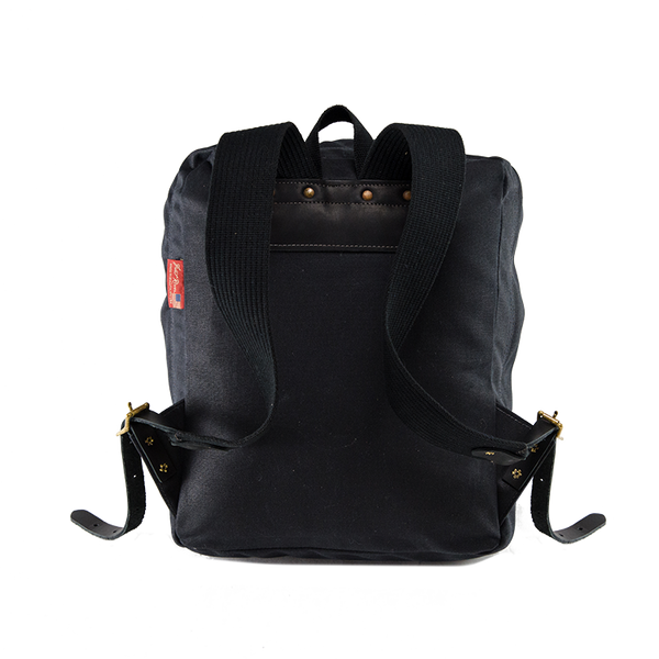 The Itinerant Daypack is also made out of our signature Heritage Black waxed canvas. 