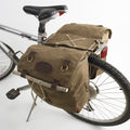 The Highway 1 Panniers are made from durable waxed canvas, premium leather, and solid brass.