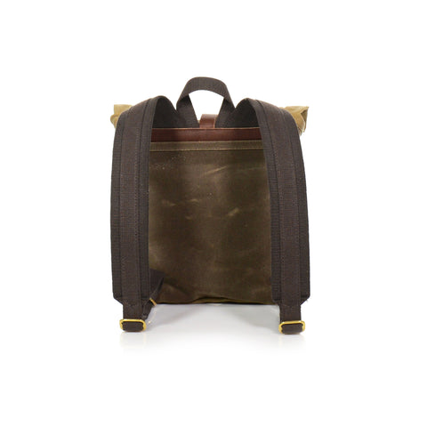 Back view of backpack heavy duty cotton webbed shoulder straps high quality brass and leather with tan and green canvas .