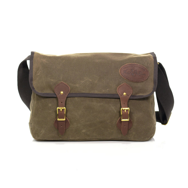 The Carrier Brief Messenger Bag is handcrafted out of our high quality waxed canvas, premium leather, solid brass, and webbed cotton. Handcrafted by Frost River Trading Co in Duluth, MN.