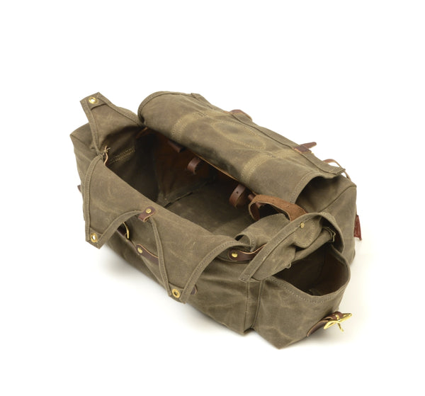 This bike bag has a large main compartment with four grommeted closure flaps for an additional layer of protection before the main flap is closed over the bag. 