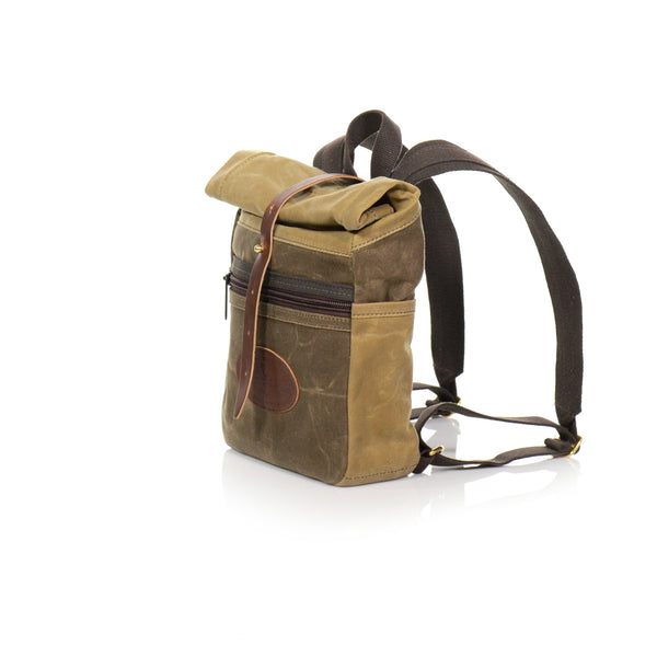 Small backpack handcrafted with premium leather and waxed canvas and a rolldown closure by Frost River.