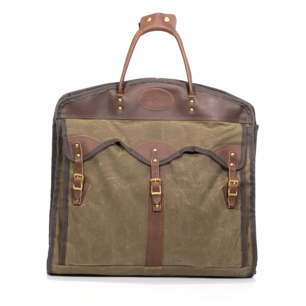 A handcrafted premium garment bag made out of high quality waxed canvas and leather. Three leather straps reinforced with brass rivets keep your clothes secured.