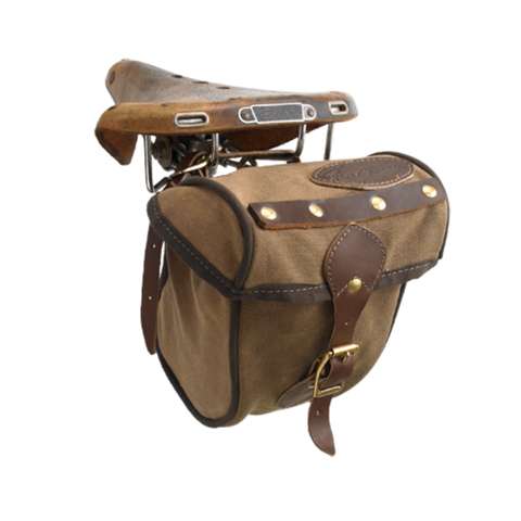 The Eco Trail Seat Bag is crafted out our high quality waxed canvas, high grade premium leather, and durable solid brass. A leather strap with a brass buckle keeps this bag shut.
