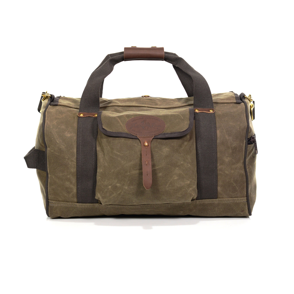 Duffel bag made from waxed canvas, webbed cotton handles with a leather hand hold that snaps over the cotton webbing for additional comfort.