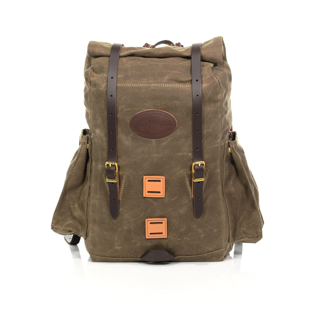 Handmade backpack made with waxed canvas leather and high-quality brass buckles with expandable side pockets for water bottles made by Frost River.