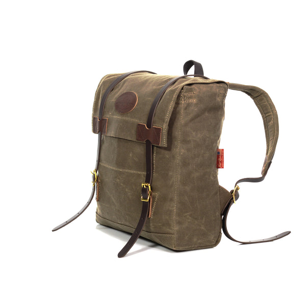 Sideview of the strong stitching and waxed canvas backpack made by Frost River Trading Co.