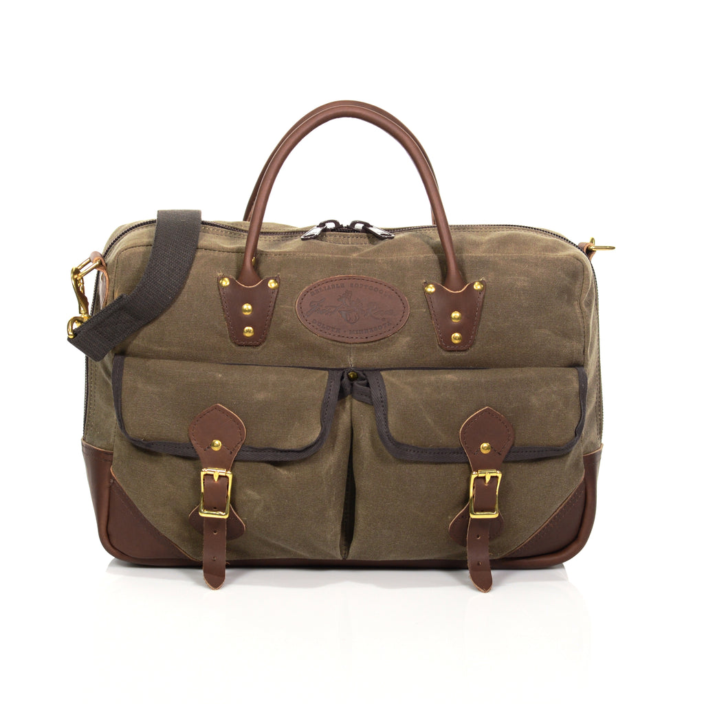 Front view of waxed canvas brief bag with leather handles, cotton webbed shoulder strap, and two side pockets with leather straps and solid brass buckles.