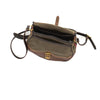 Includes a leather shoulder strap and shoulder pad that is attached to the bag with solid brass rivets.