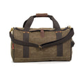 Duffel bag made by Frost River Trading Co. with a double lined waxed canvas bottom and  durable hand and shoulder straps reinforced with brass rivets.