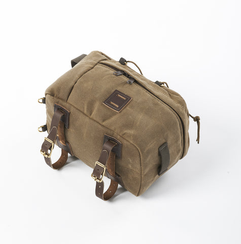 The bike bag is made from durable waxed canvas, premium leather, and solid brass.   Great by itself or in addition to our panniers.